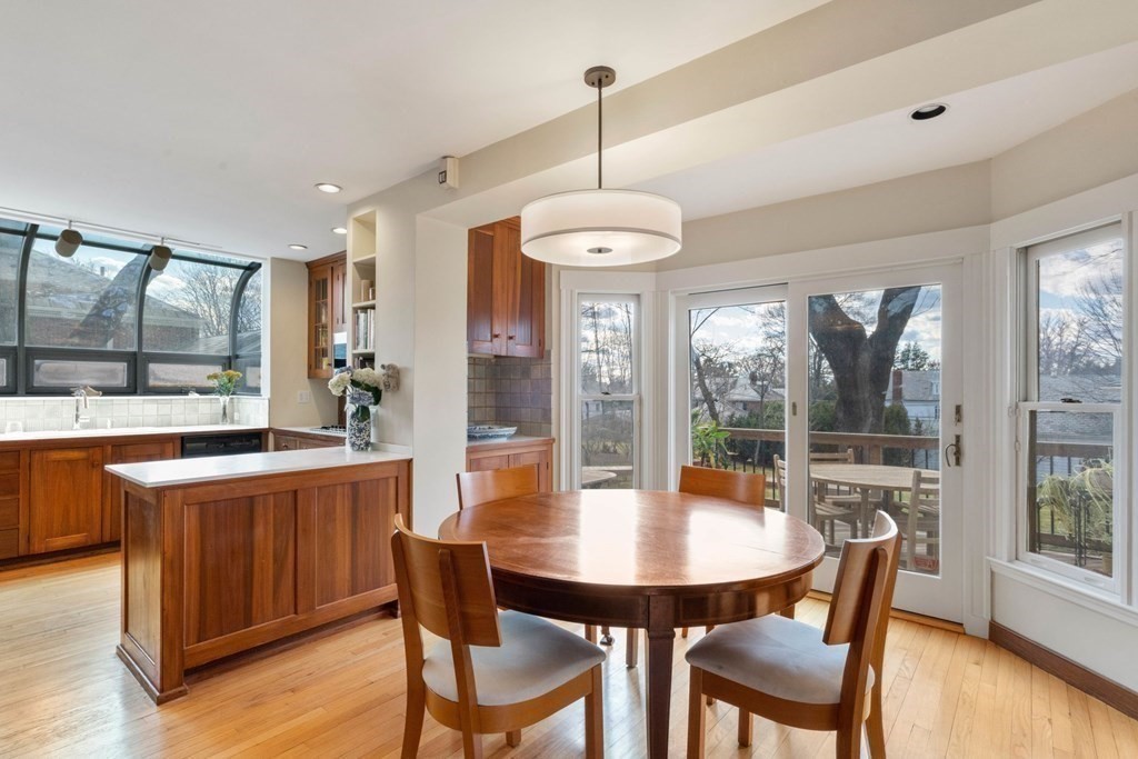 27 Nobscot Road Newton, MA 02459 - Photo 4 of 25 a kitchen with stainless steel appliances granite countertop a stove a sink a refrigerator with a dining table and chairs with wooden floor
