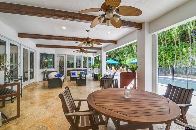 a view of a dining room with furniture wooden floor and chandelier