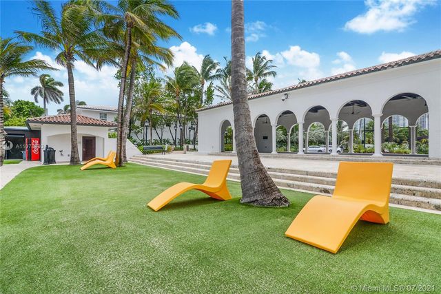 a view of a house with a backyard and a patio