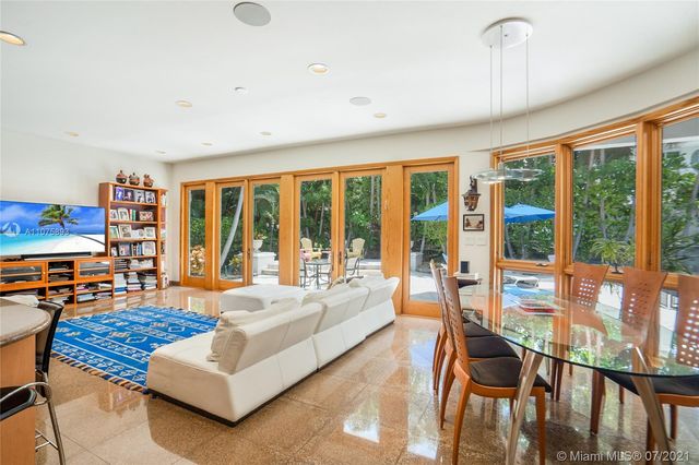 a living room with furniture and large windows