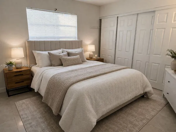 a large bed sitting in a bedroom next to a window