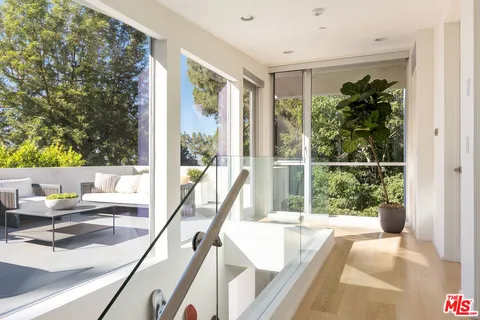 a bedroom with a bed a flat screen tv and a fireplace