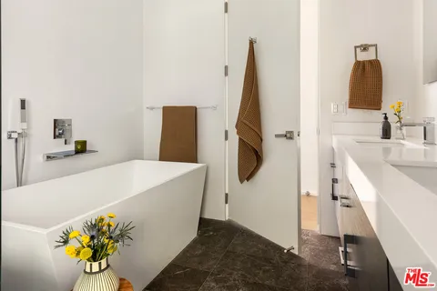 a terrace of a house with couches and pool view