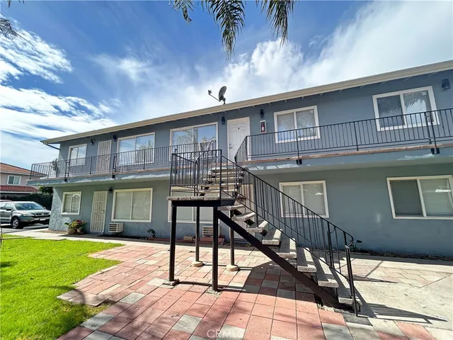 a view of a house with backyard porch and sitting area