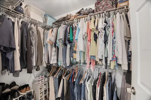 a view of walk in closet with clothes