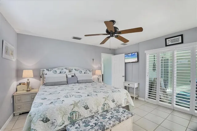 a bedroom with a large bed and a chandelier