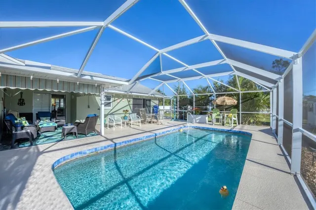 a view of a backyard with table and chairs under an umbrella