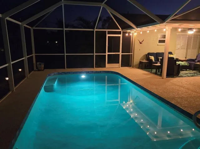 a view of a living room with kitchen countertops and wooden floor