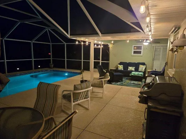 a backyard of a house with table and chairs