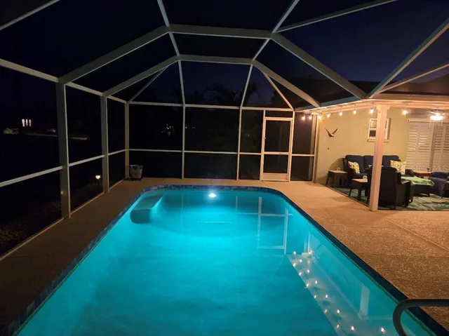 a view of a backyard with swimming pool