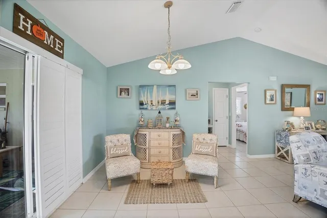 a living room with furniture a lamp and a chandelier