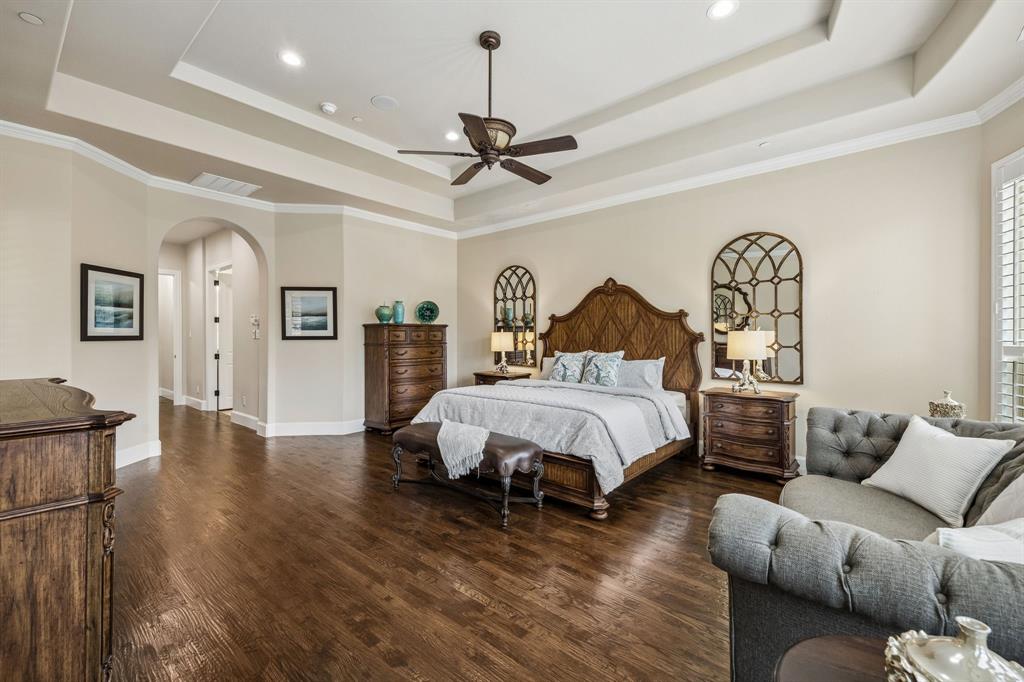 1005 Berkshire Road Southlake, TX 76092 - Photo 24 of 40 a spacious bedroom with a bed couch chandelier and a window
