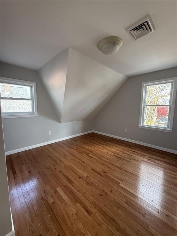 629 Highland Avenue, Unit 3 Fall River, MA 02720 - Photo 4 of 8 wooden floor in an empty room with a window