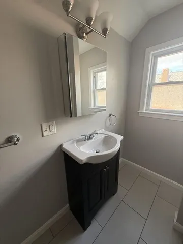 a sink and mirror with window