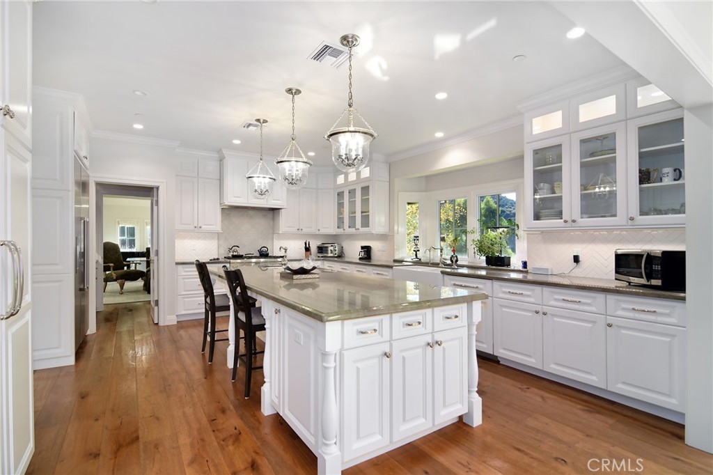 28600 Wagon Road Agoura Hills, CA 91301 - Photo 14 of 44 a kitchen with center island cabinets and wooden floor