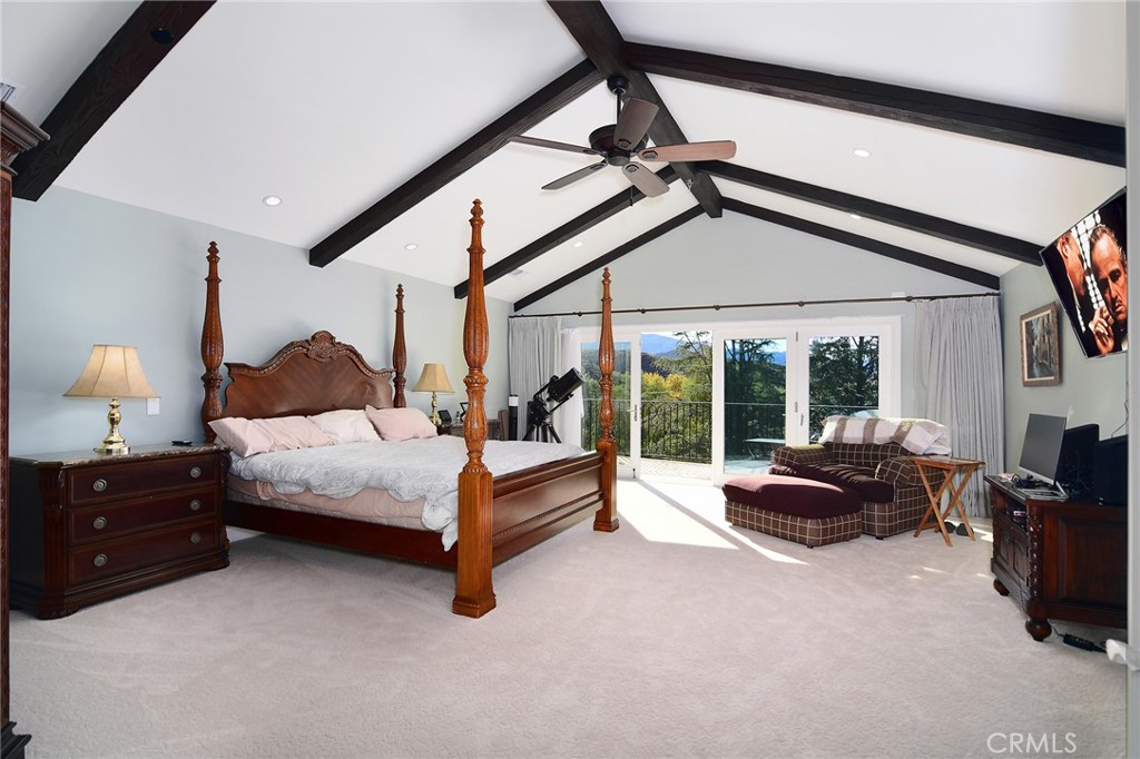 28600 Wagon Road Agoura Hills, CA 91301 - Photo 20 of 44 a spacious bedroom with a bed and a couch