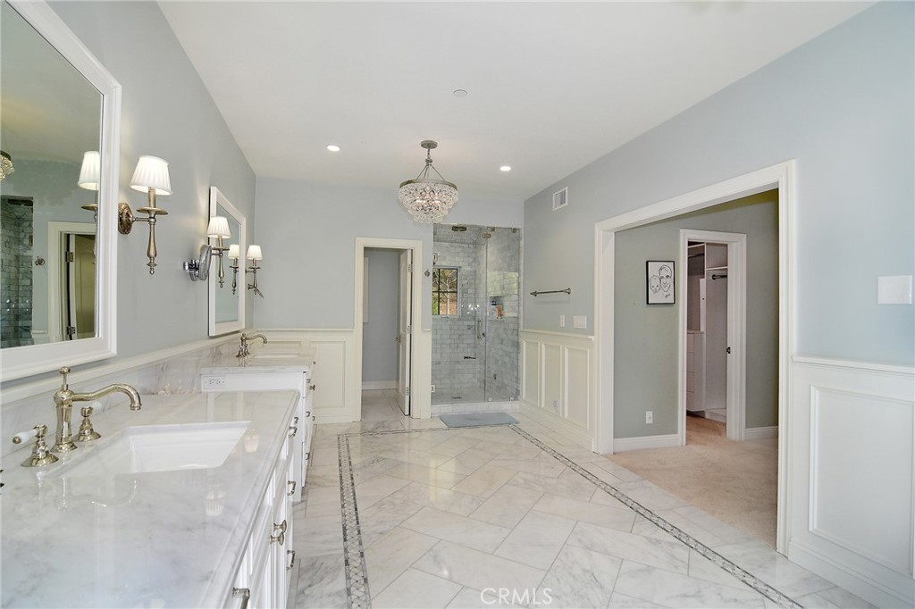 28600 Wagon Road Agoura Hills, CA 91301 - Photo 23 of 44 a bathroom with a granite countertop sink a large mirror and shower
