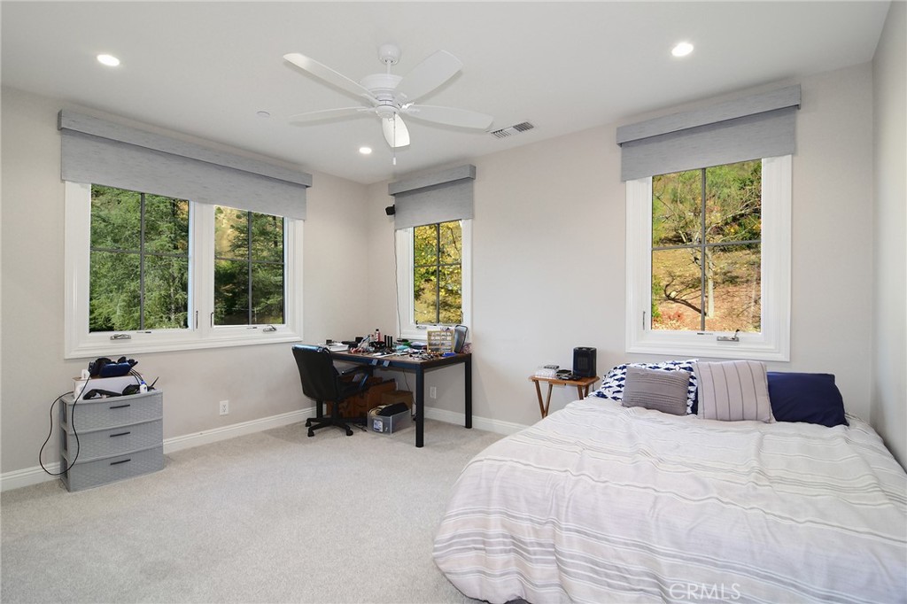 28600 Wagon Road Agoura Hills, CA 91301 - Photo 25 of 44 a bedroom with a bed and a large window