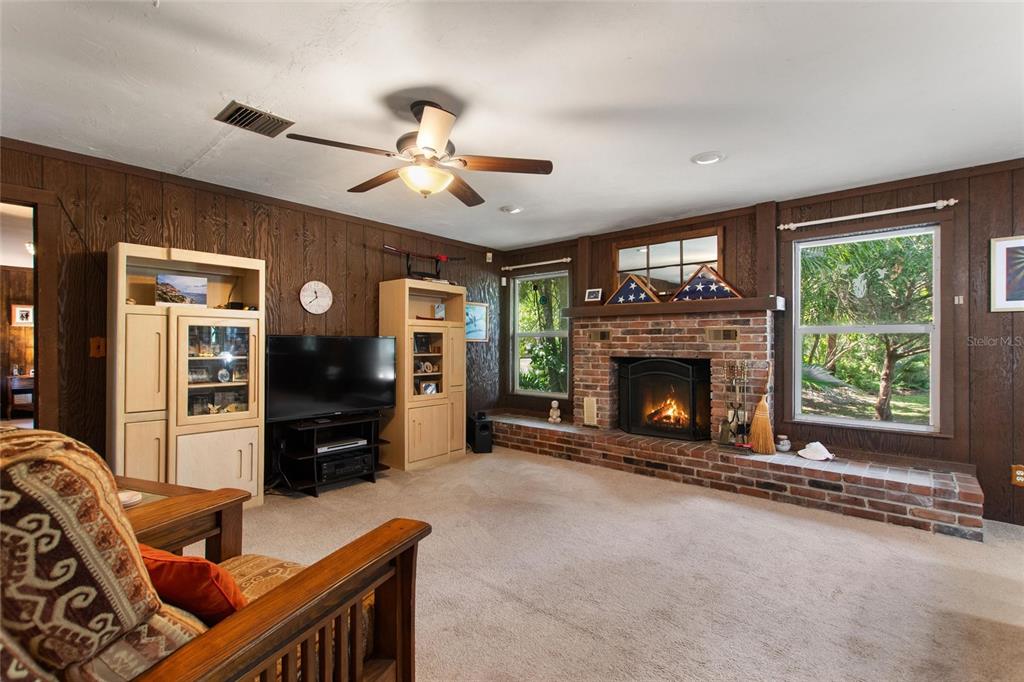 3641 Turtle Mound Road Melbourne, FL 32934 - Photo 20 of 77 a living room with furniture windows and a fireplace