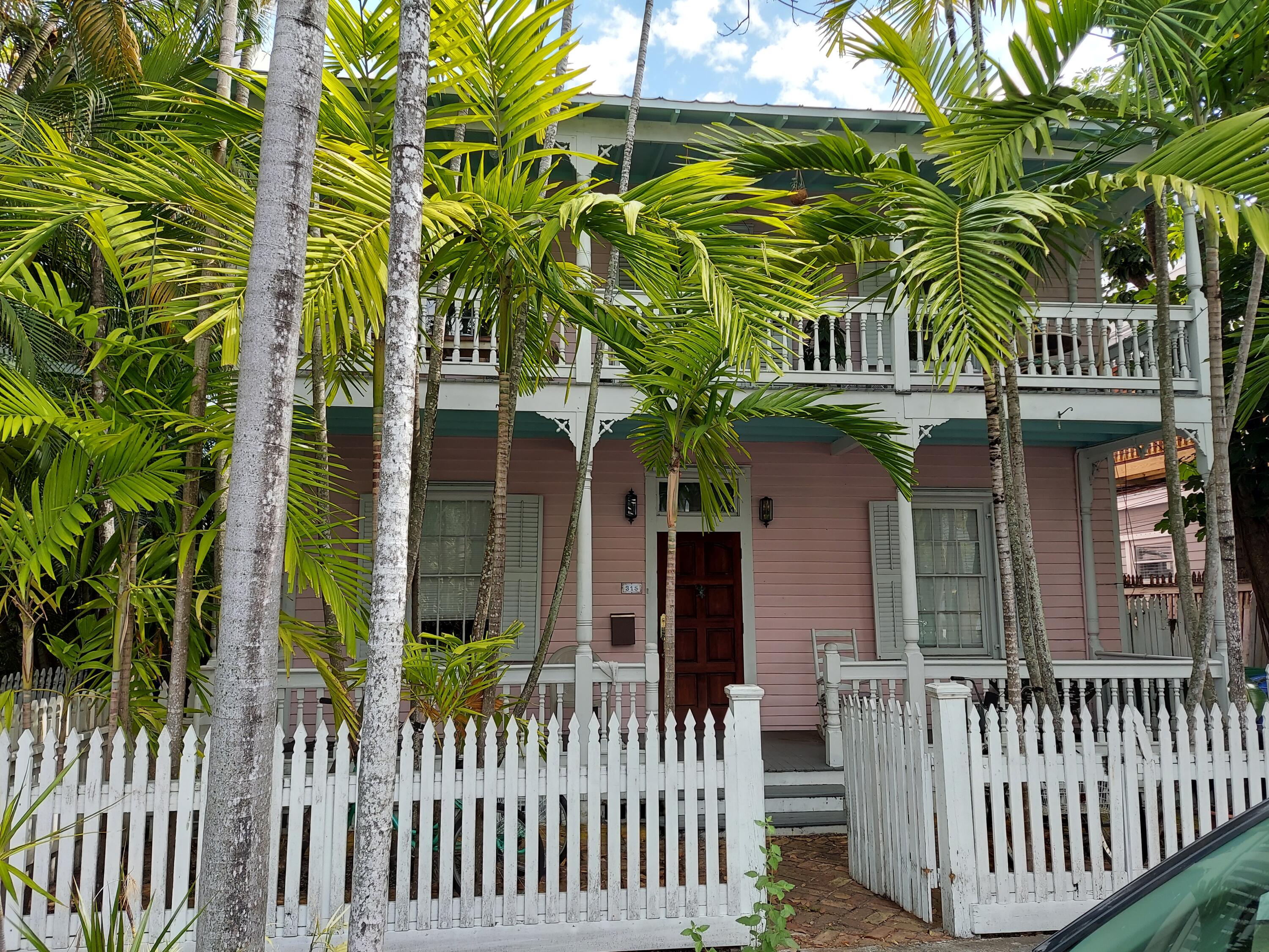 315 William Street Key West, FL 33040 - Photo 1 of 19 a view of a house with a small yard and plants