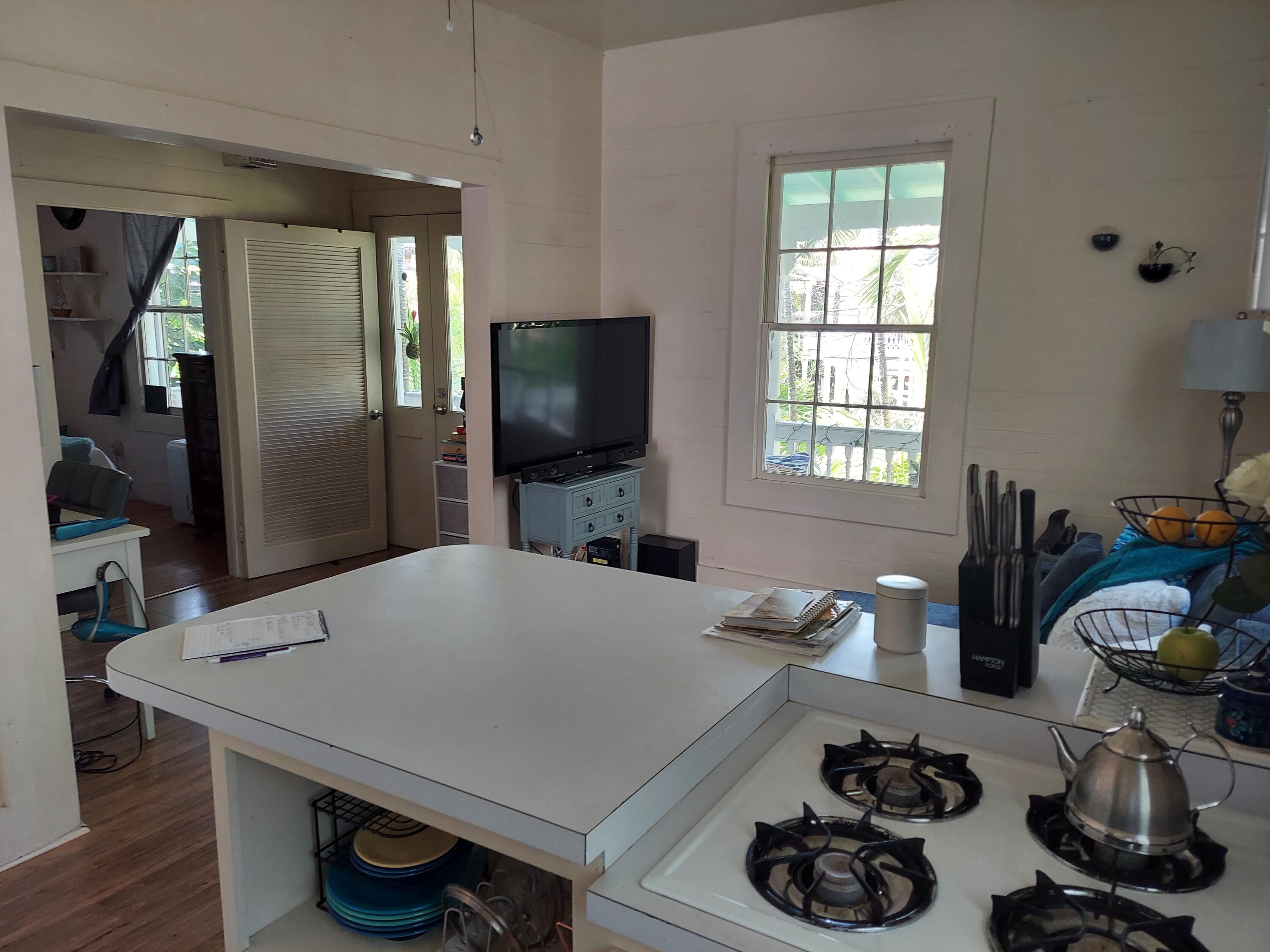 315 William Street Key West, FL 33040 - Photo 11 of 19 a kitchen with a table and chairs in it