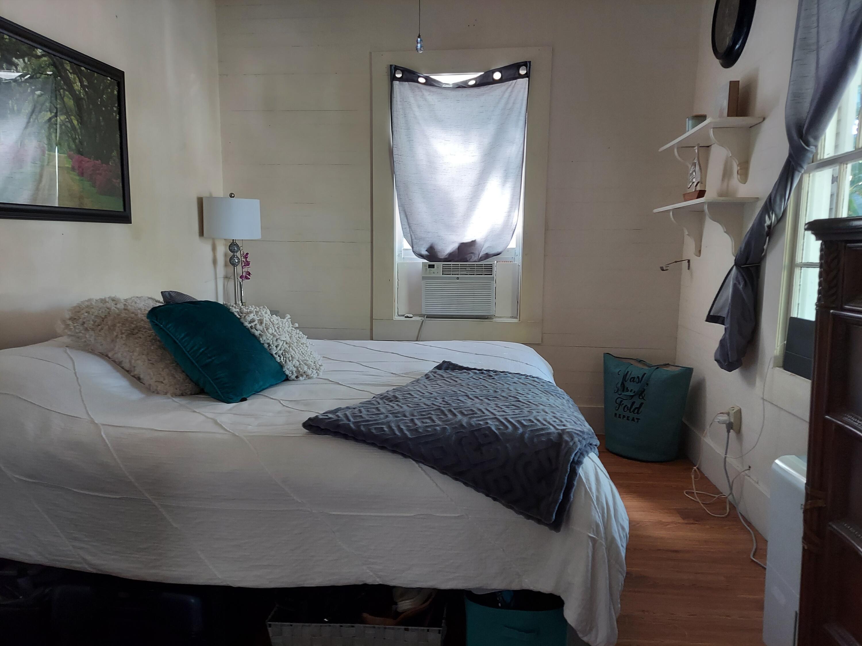 315 William Street Key West, FL 33040 - Photo 14 of 19 a bedroom with a bed and a mirror