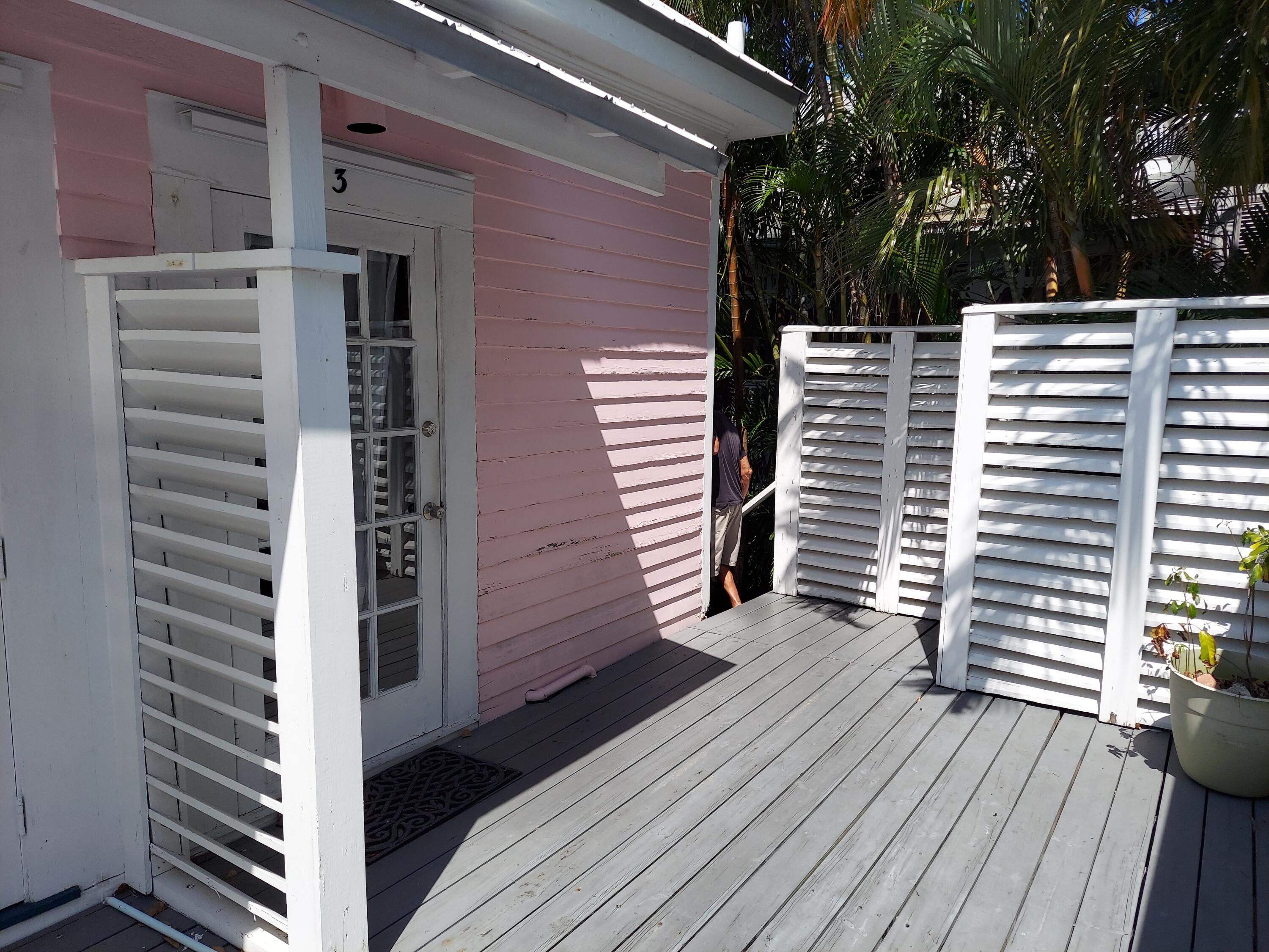 315 William Street Key West, FL 33040 - Photo 16 of 19 a view of a balcony with wooden floor and fence and a yard