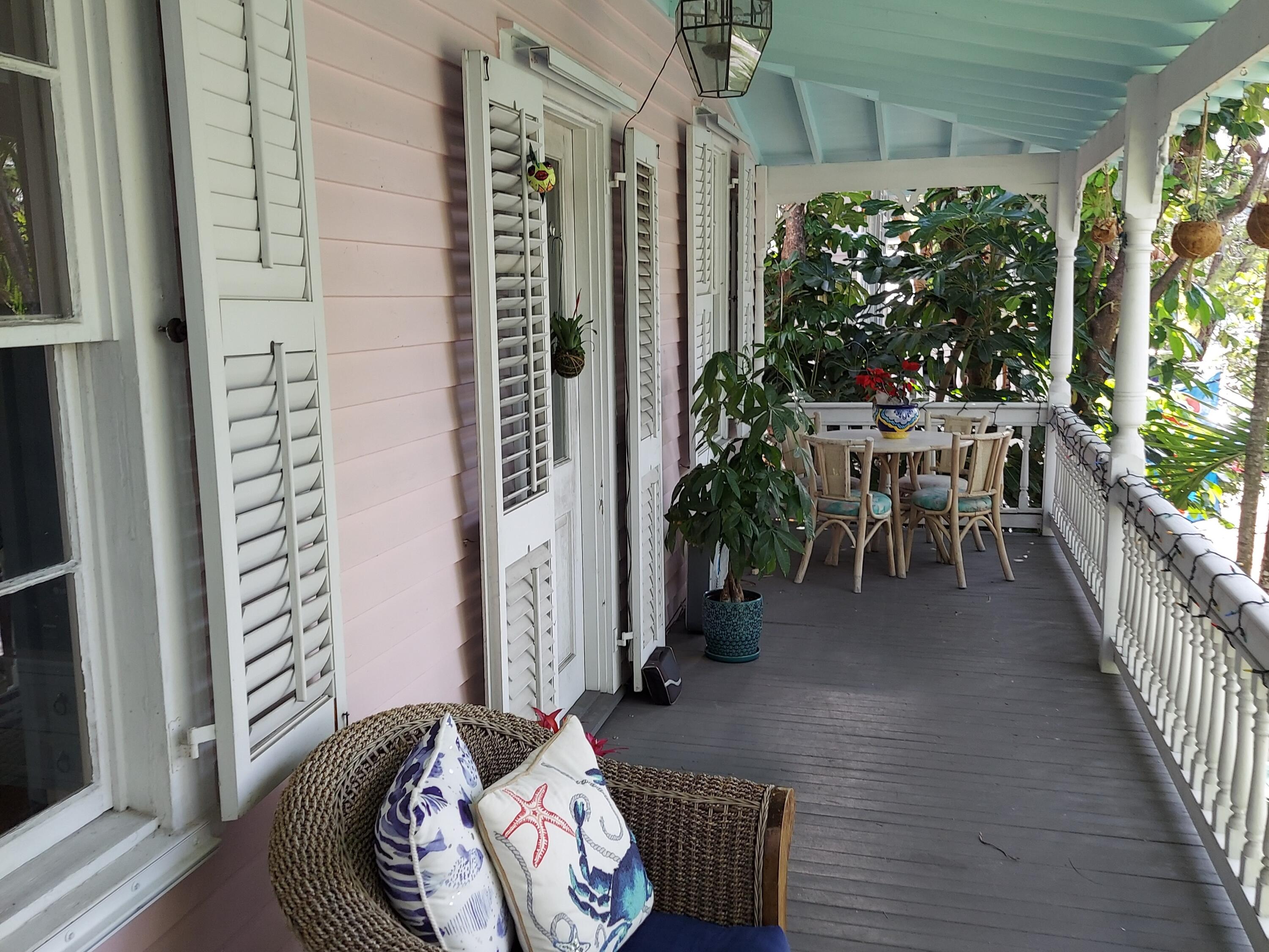 315 William Street Key West, FL 33040 - Photo 5 of 19 a view of a porch with chairs and potted plants