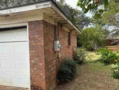 1502 Hall Street Bainbridge, GA 39819 - Photo 3 of 15 a brick building with a yard