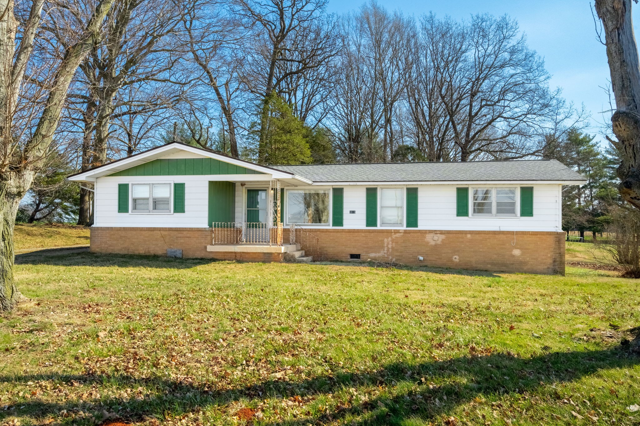 5915 Keysburg Road Adams, TN 37010 - Photo 1 of 26 a house that has a big pool with table and chairs under an umbrella