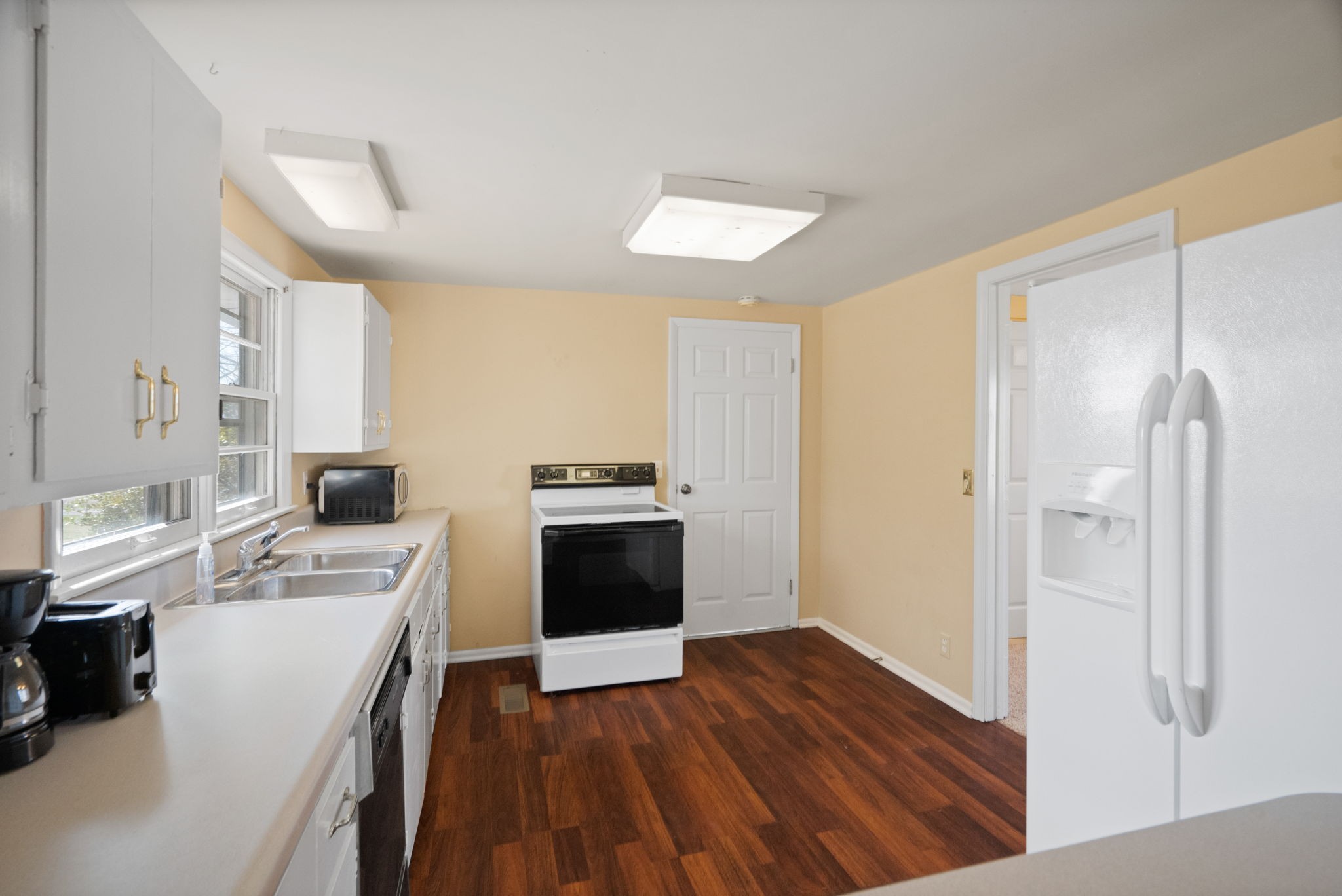5915 Keysburg Road Adams, TN 37010 - Photo 6 of 26 a kitchen with a refrigerator a stove top oven a sink and dishwasher