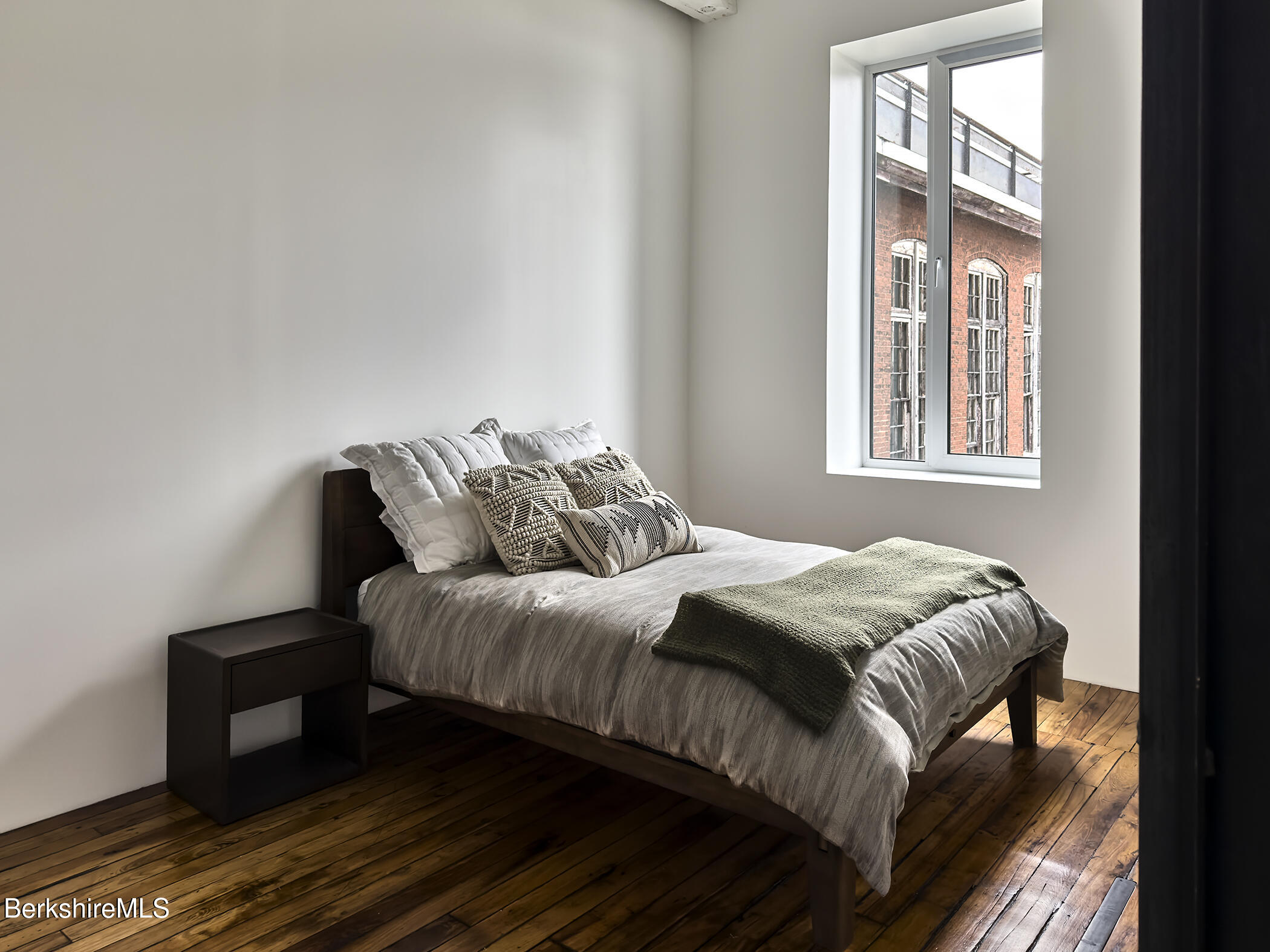 520 State Road, Unit 205 North Adams, MA 01247 - Photo 11 of 17 a bedroom with a bed and wooden floor