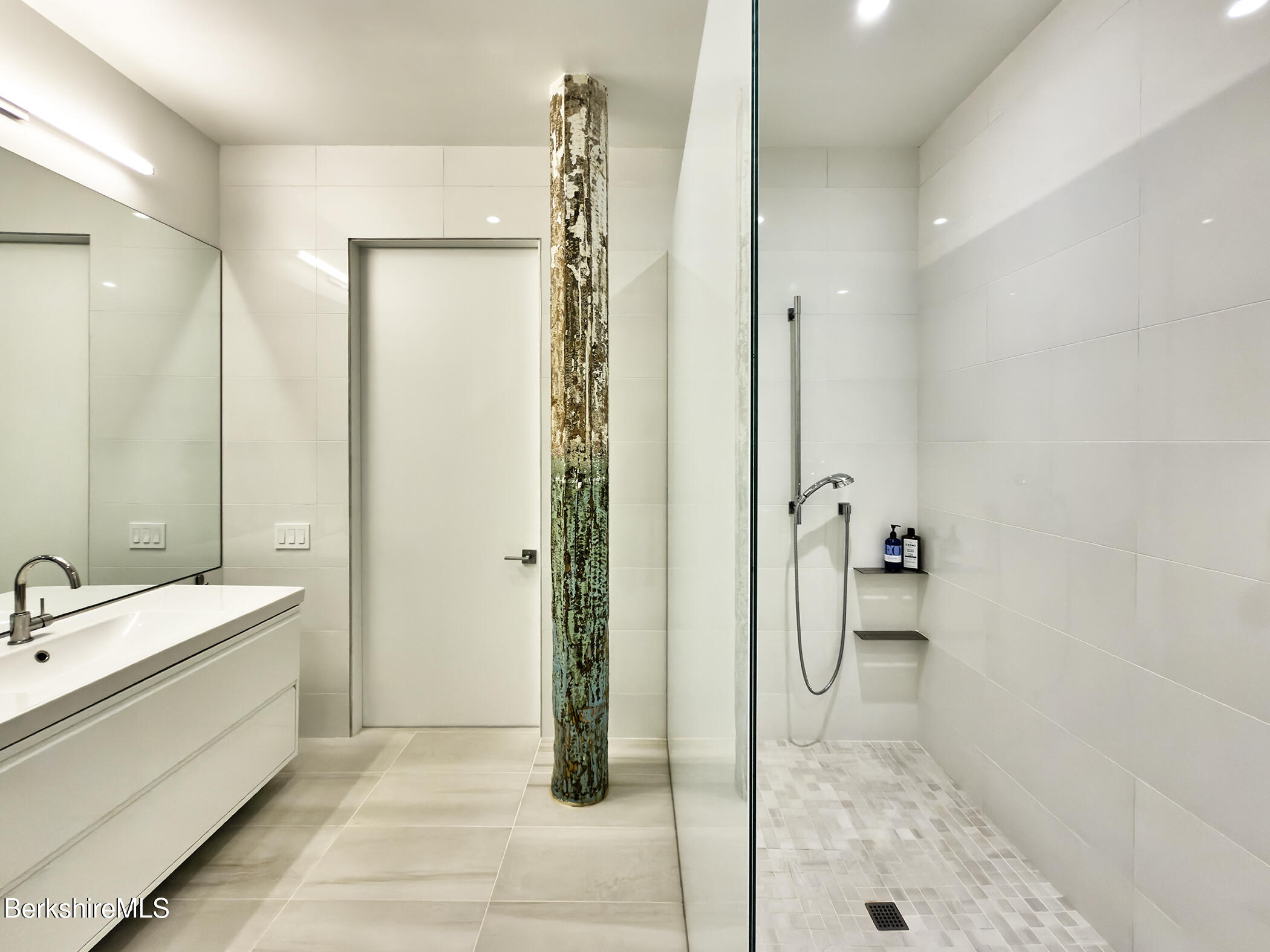 520 State Road, Unit 205 North Adams, MA 01247 - Photo 13 of 17 a bathroom with a double vanity sink a mirror and a shower