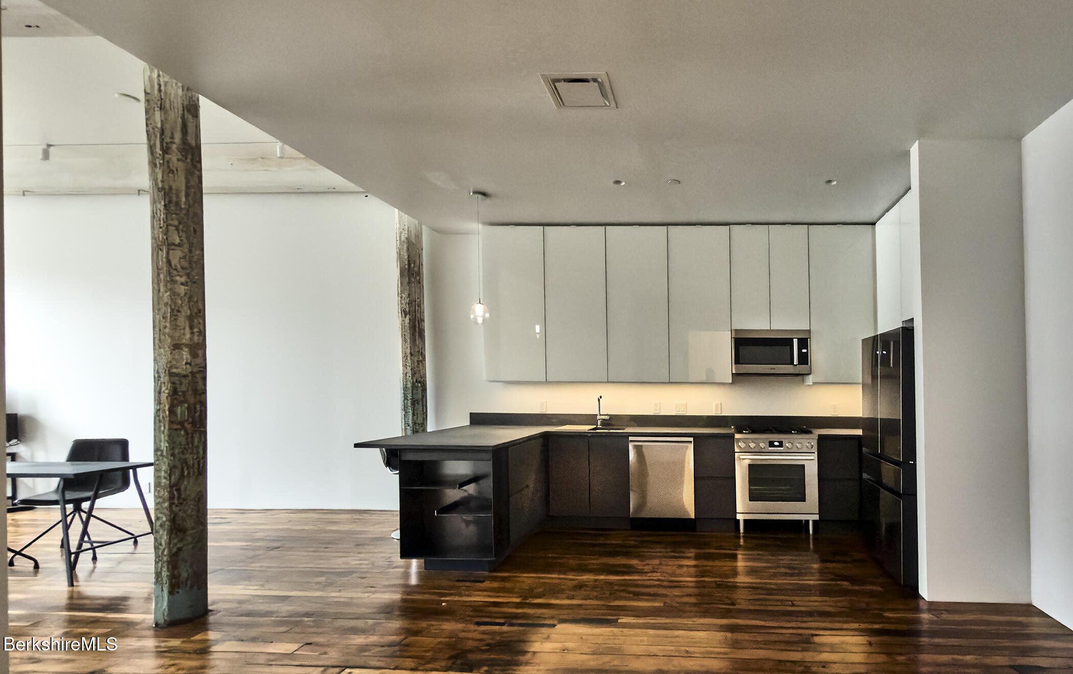 520 State Road, Unit 205 North Adams, MA 01247 - Photo 5 of 17 a kitchen with stainless steel appliances granite countertop a stove a sink and a refrigerator