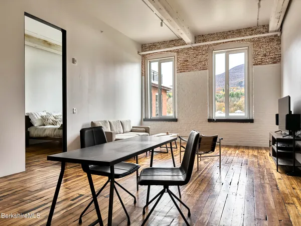 a view of a dining room with furniture window and wooden floor