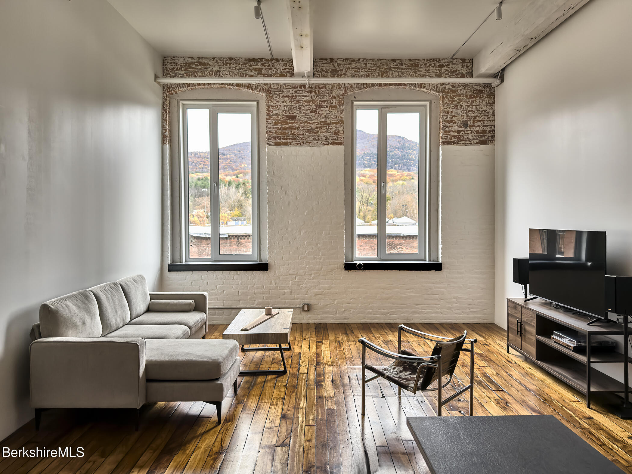 520 State Road, Unit 205 North Adams, MA 01247 - Photo 7 of 17 a living room with furniture and a flat screen tv