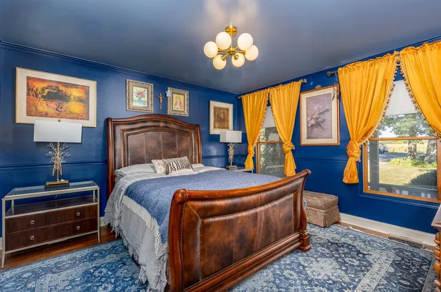 a bedroom with a bed and a chandelier