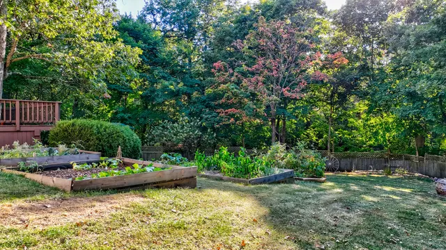a backyard of a house with a yard and outdoor seating