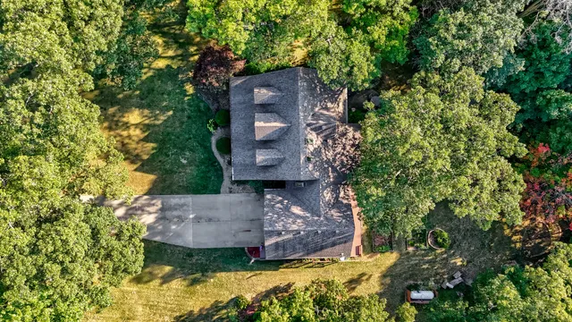 an aerial view of a house with a yard