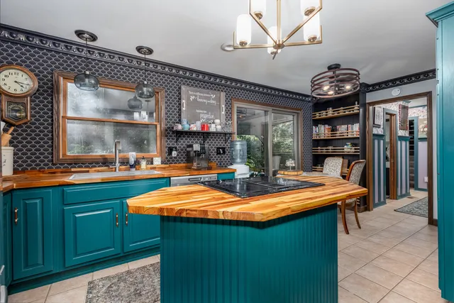 a kitchen with stainless steel appliances granite countertop a sink and a refrigerator