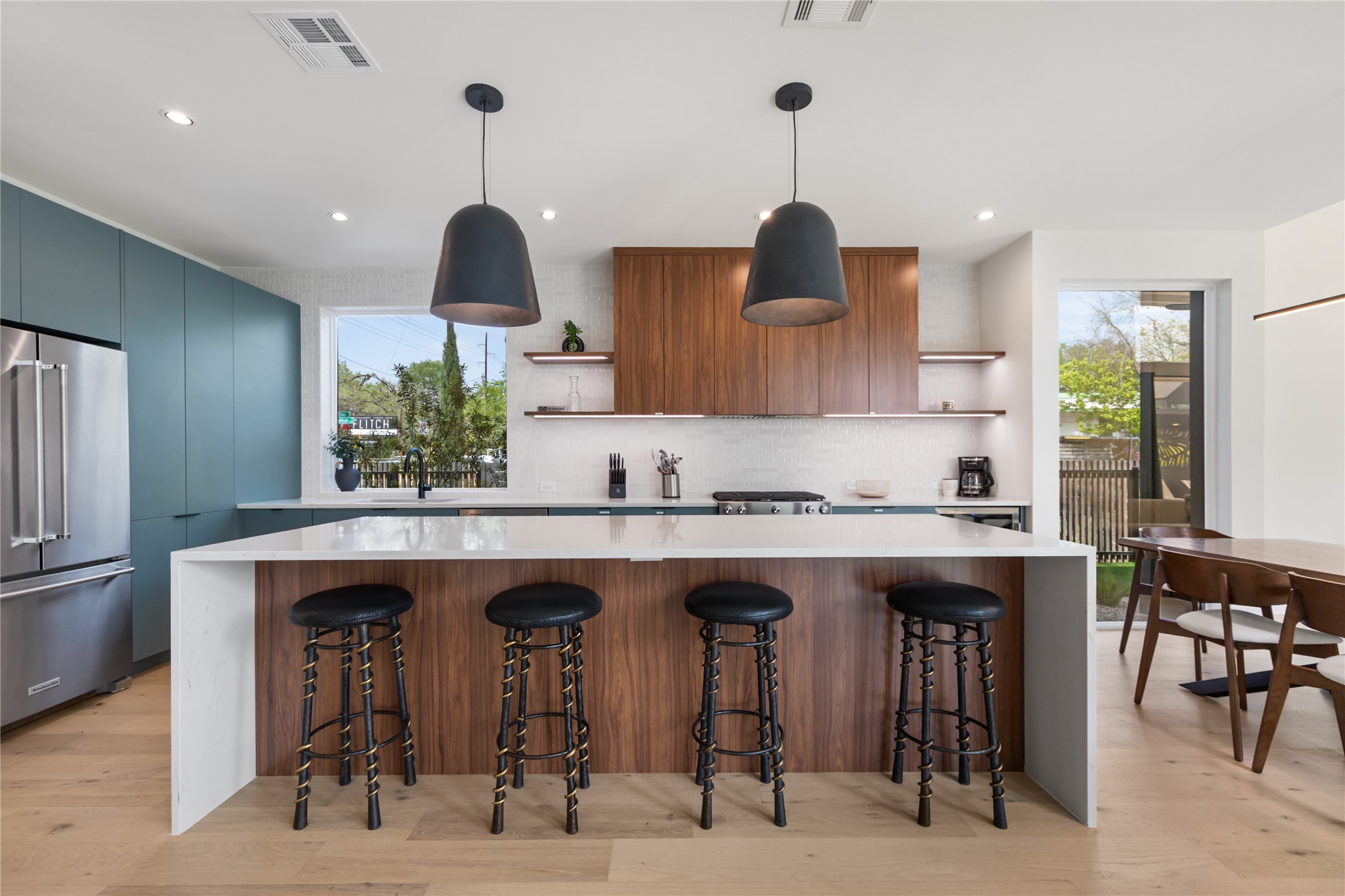 3201 Holton Street Austin, TX 78702 - Photo 4 of 39 An expansive waterfall quartz breakfast bar offers plenty of counter seating, turning this gourmet kitchen into the ultimate casual gathering spot.