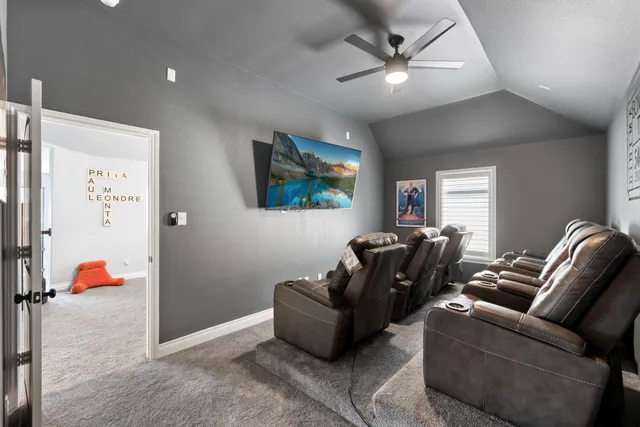 a living room with furniture and a ceiling fan
