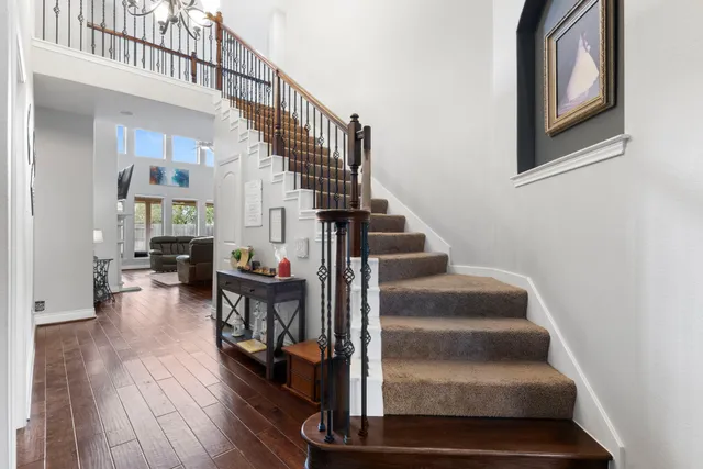 a view of entryway and hall with wooden floor
