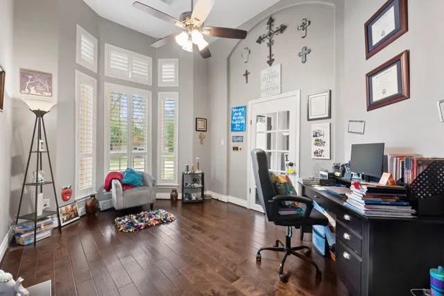 a living room with furniture floor to ceiling window and wooden floor