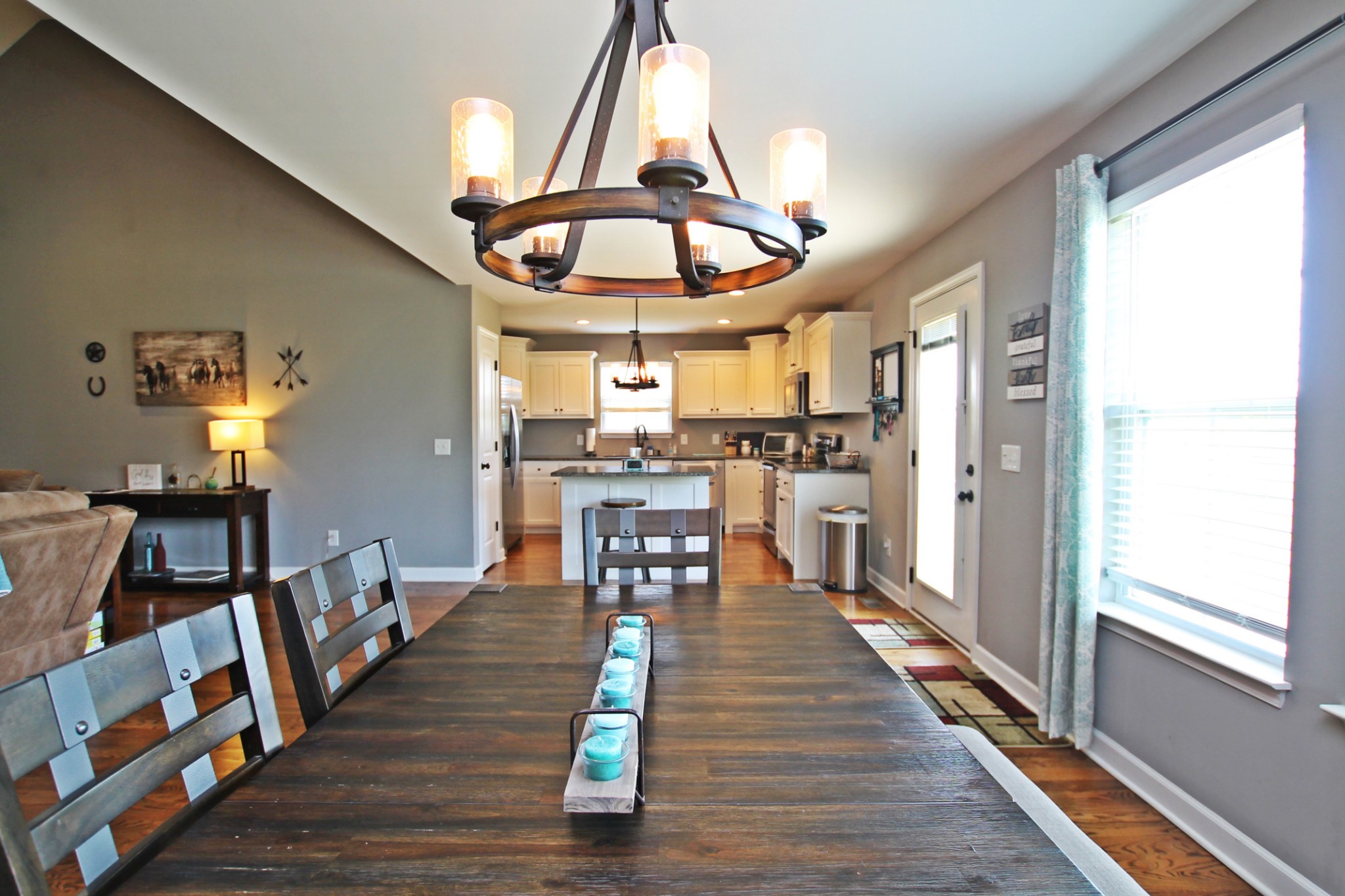 5191 Rippy Road Cross Plains, TN 37049 - Photo 15 of 48 a dining room with wooden floor a chandelier a wooden table and chairs