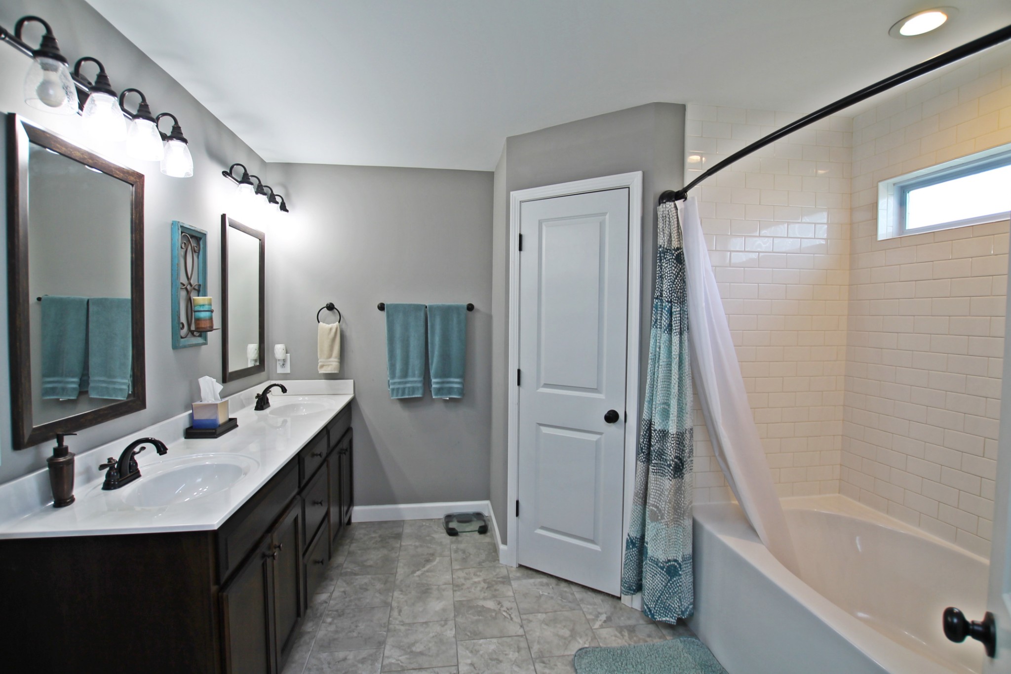 5191 Rippy Road Cross Plains, TN 37049 - Photo 20 of 48 a bathroom with a double vanity sink a mirror a bathtub and shower