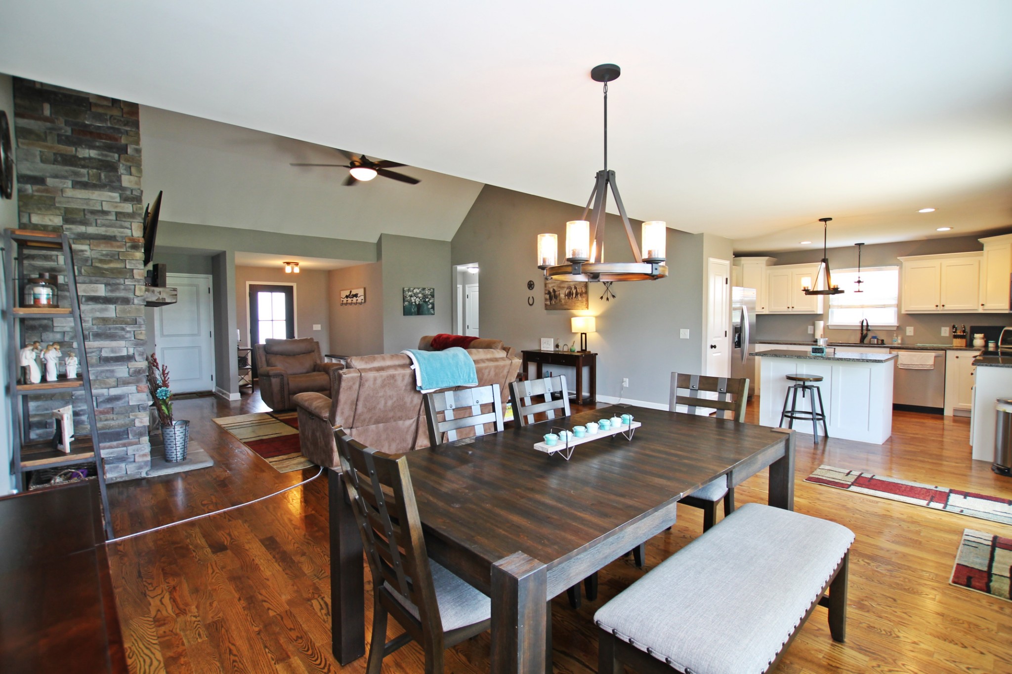 5191 Rippy Road Cross Plains, TN 37049 - Photo 7 of 48 a view of a dining room and livingroom with furniture wooden floor a rug a fireplace and a chandelier