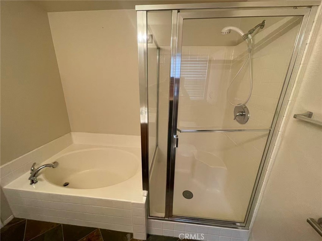 7353 Ellena West, Unit 28 Rancho Cucamonga, CA 91730 - Photo 13 of 29 a bathroom with a tub and shower