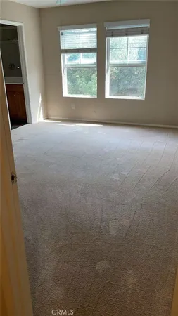 a view of an empty room with windows