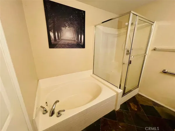 a bathroom with a tub and shower
